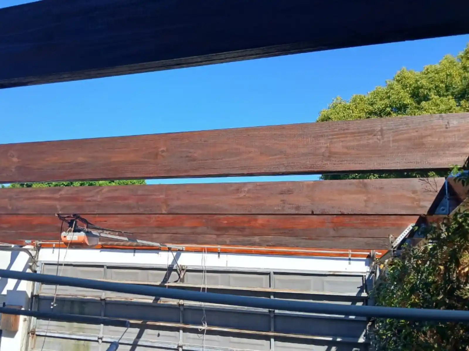 Carport beams sanded before repainting, Bergvliet replacement project