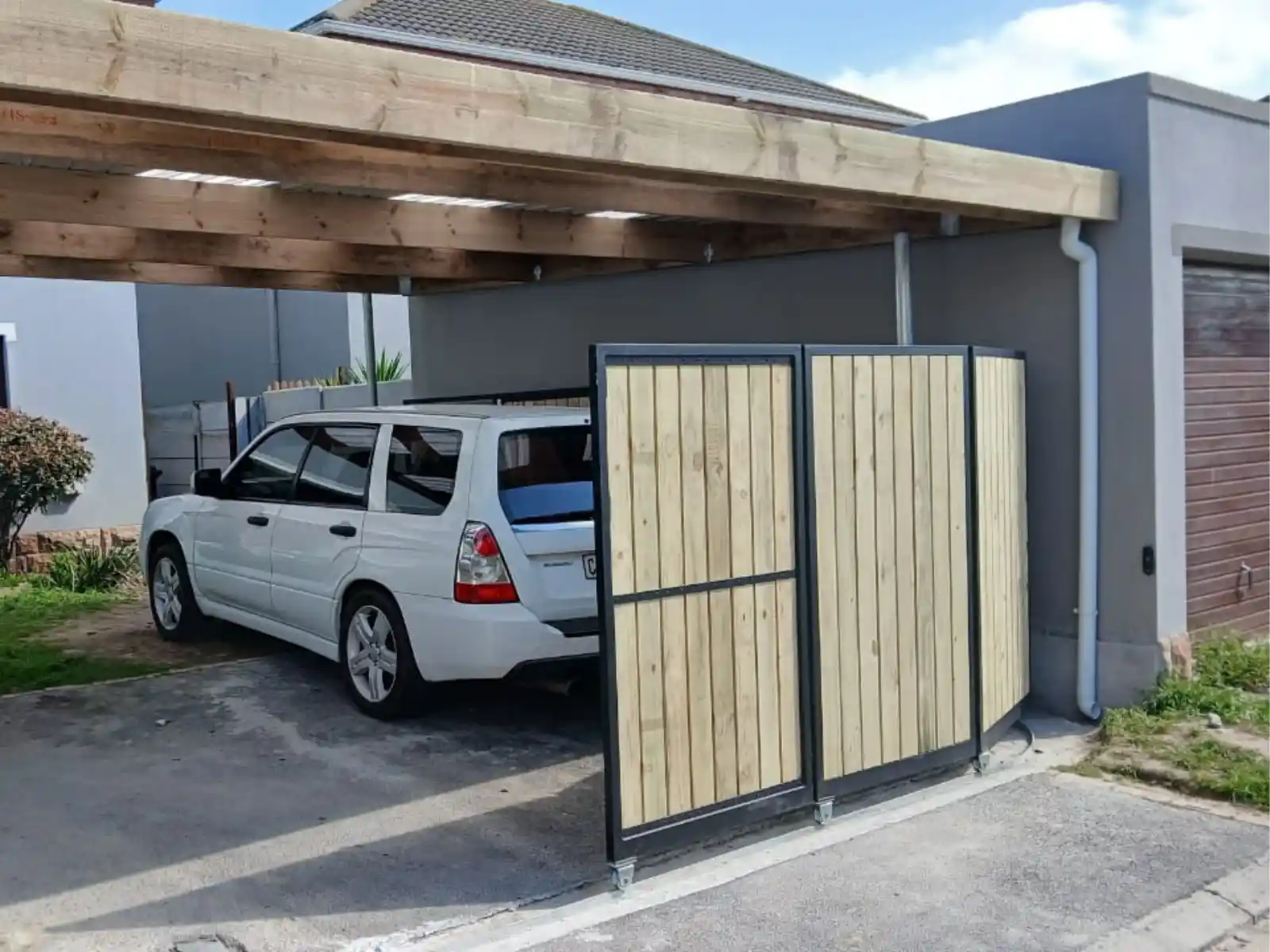 Wooden carport with car parked, Fresnaye